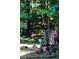 Scenic backyard featuring a tree stump adorned with a charming metal daisy, surrounded by lush greenery at 150 Ashley Dr, Fayetteville, GA 30214