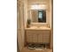 Bathroom with a modern vanity, ample storage, and a decorative mirror at 150 Ashley Dr, Fayetteville, GA 30214