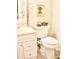 Cozy bathroom featuring a white vanity and cabinet, a toilet and decorative accents at 150 Ashley Dr, Fayetteville, GA 30214