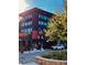 Modern multi-story building with brick facade and Enzo restaurant signage, plus sidewalk and parking at 150 Ashley Dr, Fayetteville, GA 30214