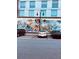 Building exterior featuring a mural of children reading, with parked cars in front and a light post at 150 Ashley Dr, Fayetteville, GA 30214