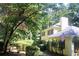 A lovely home with a lush tree lined yard and shrubbery at 150 Ashley Dr, Fayetteville, GA 30214