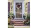 Charming front entrance with a decorative wreath, a storm door, and decorative features at 150 Ashley Dr, Fayetteville, GA 30214