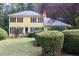 Charming yellow two-story home with red shutters, mature landscaping and a well-maintained lawn at 150 Ashley Dr, Fayetteville, GA 30214