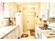 Galley kitchen featuring white appliances, white cabinets and an open space at 150 Ashley Dr, Fayetteville, GA 30214