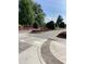 Paved street and landscaped median with colorful flowers and manicured bushes at 150 Ashley Dr, Fayetteville, GA 30214