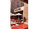 Restaurant outdoor dining area with red tables, chairs, and umbrellas, perfect for enjoying meals outside at 150 Ashley Dr, Fayetteville, GA 30214