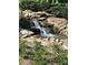 Serene waterfall with natural rocks and lush greenery, creating a peaceful environment at 150 Ashley Dr, Fayetteville, GA 30214