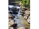 Scenic shot of waterfall cascading through rocks, enhancing the tranquility of the community at 150 Ashley Dr, Fayetteville, GA 30214