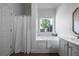Bathroom with soaker tub, window, and neutral color palette at 3047 Standing Rock Ct, Lithia Springs, GA 30122