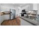 Well-lit kitchen featuring stainless steel appliances, white cabinets, and solid surface countertops at 3047 Standing Rock Ct, Lithia Springs, GA 30122