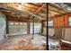 Unfinished basement with two car garage door and unfinished walls and ceiling with insulation at 4076 Whistler Dr, Douglasville, GA 30135