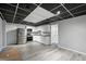 Basement kitchen featuring a drop ceiling, white cabinets, stainless steel appliances, and gray walls at 4076 Whistler Dr, Douglasville, GA 30135