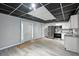Basement kitchen featuring a drop ceiling, white cabinets, stainless steel appliances, and an exterior door at 4076 Whistler Dr, Douglasville, GA 30135