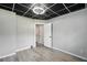 Basement bedroom featuring a drop ceiling, gray walls, and wood-look flooring with a closet at 4076 Whistler Dr, Douglasville, GA 30135
