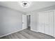 Bedroom featuring modern ceiling fan, wood-look laminate flooring, a closet and a view of an entryway at 4076 Whistler Dr, Douglasville, GA 30135