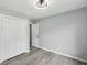This bedroom offers neutral-toned walls, modern ceiling fan, spacious closet and wood-look laminate flooring at 4076 Whistler Dr, Douglasville, GA 30135