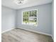 Bedroom featuring natural light, wood-look laminate flooring and a street view at 4076 Whistler Dr, Douglasville, GA 30135