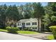 Beautiful home with mature trees, lush lawn, and a paved driveway at 4076 Whistler Dr, Douglasville, GA 30135