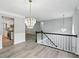 Spacious hallway with hardwood floors, stylish chandeliers and an open view to the kitchen at 4076 Whistler Dr, Douglasville, GA 30135