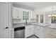 Bright kitchen features white cabinets, granite countertops, stainless steel appliances, and a view to the outdoors at 4076 Whistler Dr, Douglasville, GA 30135