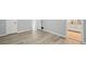 Main bedroom featuring a view to the bathroom, wood-look laminate flooring and neutral-toned walls at 4076 Whistler Dr, Douglasville, GA 30135