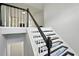 Bright staircase with freshly painted white and black banisters and newly installed floor coverings at 4076 Whistler Dr, Douglasville, GA 30135