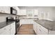 Beautiful kitchen features stainless steel appliances, white subway tile backsplash, and a large island with granite countertops at 108 Berwick Crossing, Dallas, GA 30157