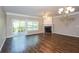 Spacious living room featuring a fireplace, ceiling fan, and sliding glass door leading to the patio at 11768 Wellsley Way, Johns Creek, GA 30005