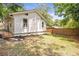 Well-maintained backyard with lush grass and a fence, surrounded by mature trees at 2294 Hill St, Atlanta, GA 30318