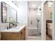 Modern bathroom with double sinks, a glass-enclosed shower, and contemporary fixtures at 2294 Hill St, Atlanta, GA 30318