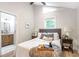 Bright bedroom featuring a window, a bed with decorative pillows, and an ensuite bathroom at 2294 Hill St, Atlanta, GA 30318