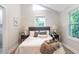 Cozy bedroom features natural light from a window and neutral tones, creating a peaceful atmosphere at 2294 Hill St, Atlanta, GA 30318