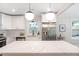 Bright kitchen features a large island, stainless appliances and elegant pendant lighting at 2294 Hill St, Atlanta, GA 30318