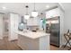Modern kitchen includes stainless appliances, island, and stylish pendant lighting at 2294 Hill St, Atlanta, GA 30318