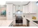 Updated kitchen featuring stainless appliances, white cabinetry and stone countertops at 2294 Hill St, Atlanta, GA 30318