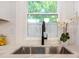 Close up of the stainless sink and faucet in this updated kitchen at 2294 Hill St, Atlanta, GA 30318