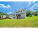 Expansive backyard with lush green grass and mature trees and a cozy deck at 3961 S River Ln, Ellenwood, GA 30294