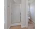 Bathroom with glass-door shower and wood-look flooring at 3961 S River Ln, Ellenwood, GA 30294