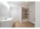 Bright bathroom featuring white vanity with updated fixtures, wood-look flooring, and separate tiled shower at 3961 S River Ln, Ellenwood, GA 30294