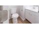 Clean, modern bathroom features white cabinetry, chrome faucet and fixtures, and light wood laminate floors at 3961 S River Ln, Ellenwood, GA 30294