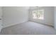 Comfortable carpeted bedroom with a large window providing ample natural light at 3961 S River Ln, Ellenwood, GA 30294