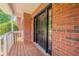 Charming brick home with covered front porch and modern black front door at 3961 S River Ln, Ellenwood, GA 30294
