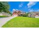 Charming brick home featuring a well-maintained lawn and a spacious driveway leading to a two-car garage at 3961 S River Ln, Ellenwood, GA 30294
