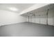 Spacious two car garage featuring an automatic door and sealed concrete flooring at 3961 S River Ln, Ellenwood, GA 30294