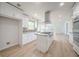 A spacious, light-filled kitchen with white cabinets, stainless steel appliances, and a sizable center island at 3961 S River Ln, Ellenwood, GA 30294
