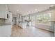 Bright, spacious kitchen featuring white cabinets, a large island, stainless appliances and access to the back deck at 3961 S River Ln, Ellenwood, GA 30294