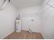 Utility Room with updated laminate flooring and white walls and ceiling, including Washer/Dryer Hookups at 3961 S River Ln, Ellenwood, GA 30294
