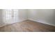 Bright living room features neutral paint and light wood floors at 3961 S River Ln, Ellenwood, GA 30294