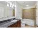 Clean bathroom featuring granite countertop, tile flooring, and bathtub with shower at 44 Peachtree Nw Pl # 1828, Atlanta, GA 30309
